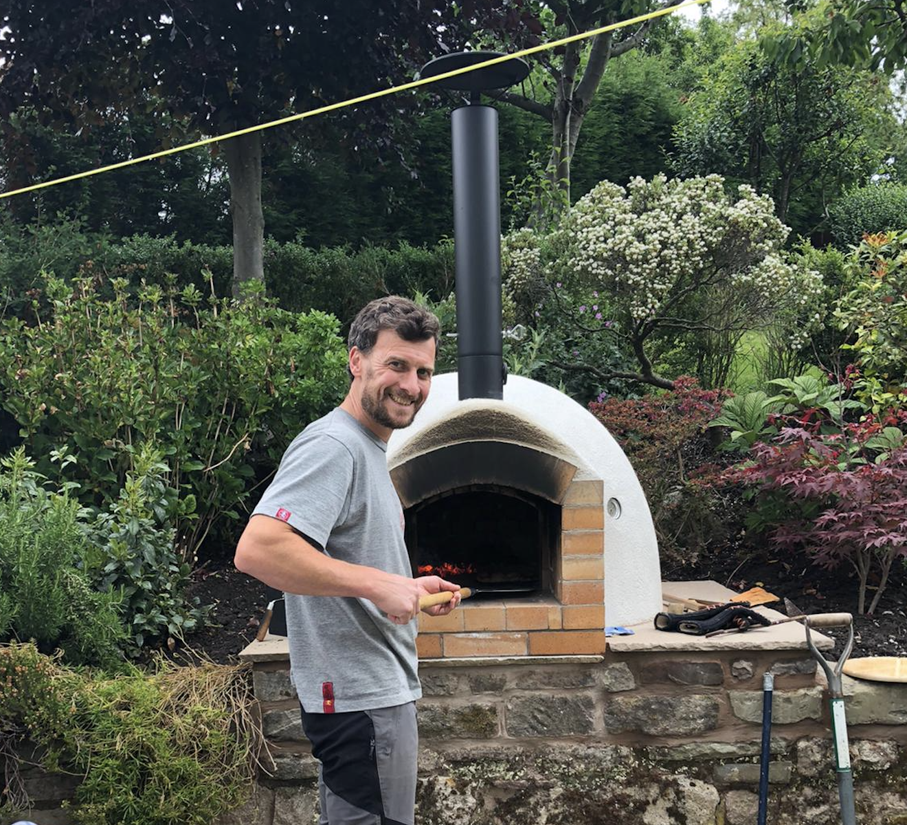 Gareth making pizza in his self built traditional brick pizza oven